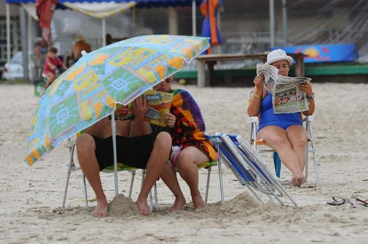 Veranistas se protegem do vento com guarda-s&oacute;is