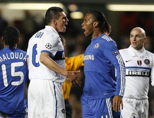 L&uacute;cio e Drogba discutem durante a partida