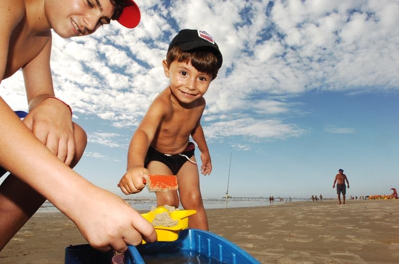 Mesmo com c&eacute;u nublado e vento, o menino se divertiu brincando no mar e na areia com o irm&atilde;o Peter Natan