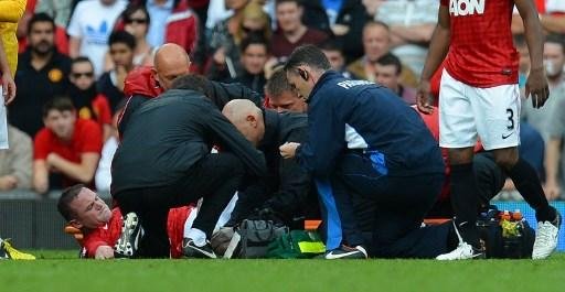 Rooney &eacute; atendido durante a partida contra o Fulham 