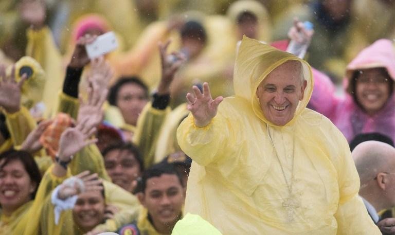 Peregrinos aclamaram Francisco que, como eles, vestia uma capa de chuva amarela