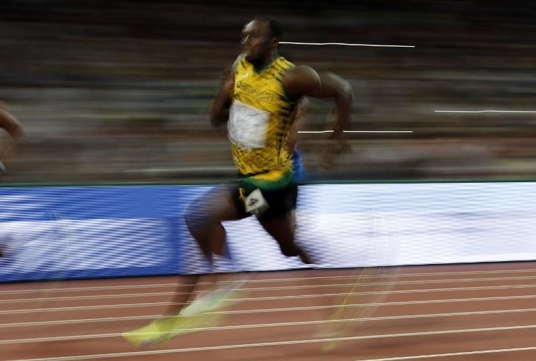 Bolt (foto) e Gatlin avan&ccedil;am sem sustos &agrave; semifinal dos 200 metros