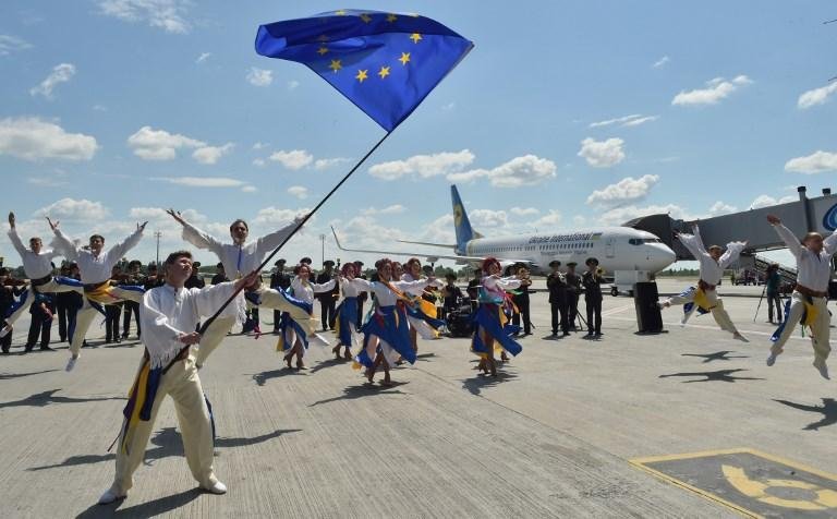 Trupe de dan&ccedil;arinas ucranianas atua na pista do aeroporto de Boryspil celebrando primeiro dia da medida