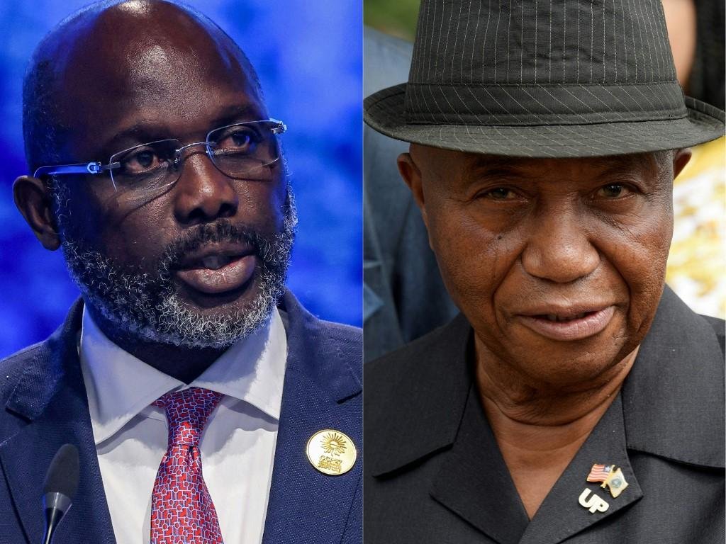 Weah (E) destacou "vit&oacute;ria da democracia" no pa&iacute;s, ap&oacute;s vantagem de Boakai (D)