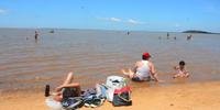 Tempo firme, com poucas nuvens, levou famílias de Porto Alegre para buscar refúgio do calor na praia do Lami