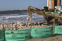 Operators work with heavy machinery on the coast of Cartagena, Colombia, on February 23, 2024.