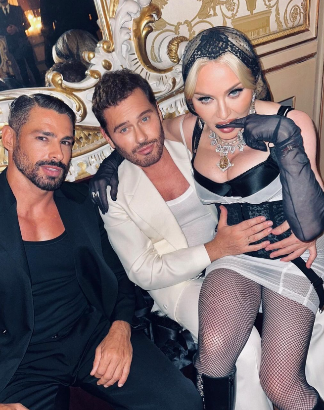 Em uma das fotos, o brasileiro aparece ao lado do fot&oacute;grafo de moda Mert Alas, que segura Madonna no colo.