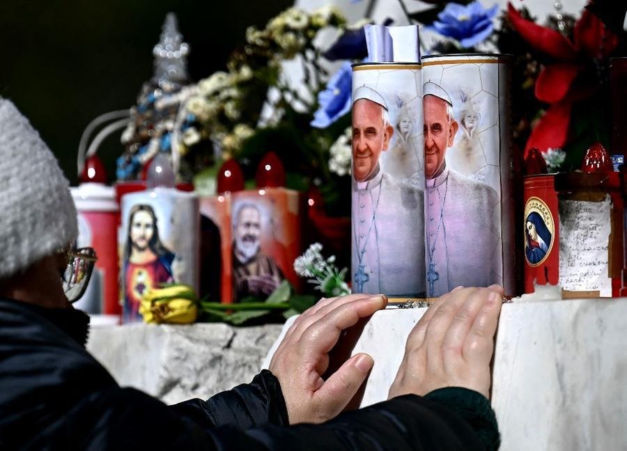 Pessoas rezam em frente &agrave; um foto de Francisco, pedindo a recupera&ccedil;&atilde;o do Papa