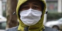 Cidadãos chineses adotam precauções para conter vírus