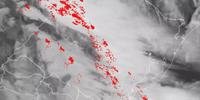 Faixa de nuvens do sistema frontal acompanhado de muitos raios (pontos vermelhos) em alguns municípios do RS