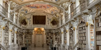 O salão da biblioteca, com 70 metros de comprimento, conta com 70.000 livros, como manuscritos que datam do século VIII