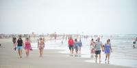 Veranistas aproveitaram para caminhar na beira da praia de Torres